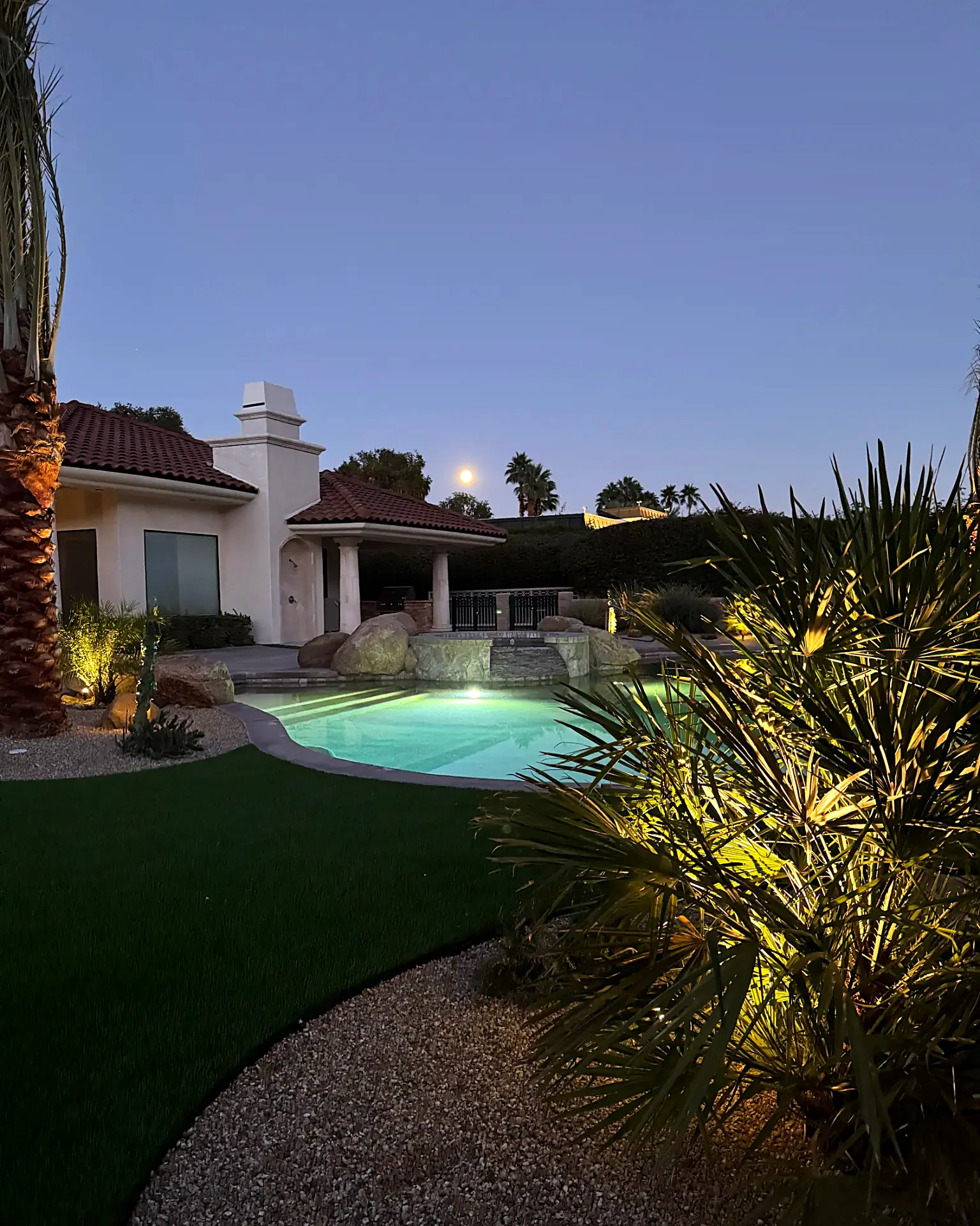 Twilight pool and spa with landscape lighting