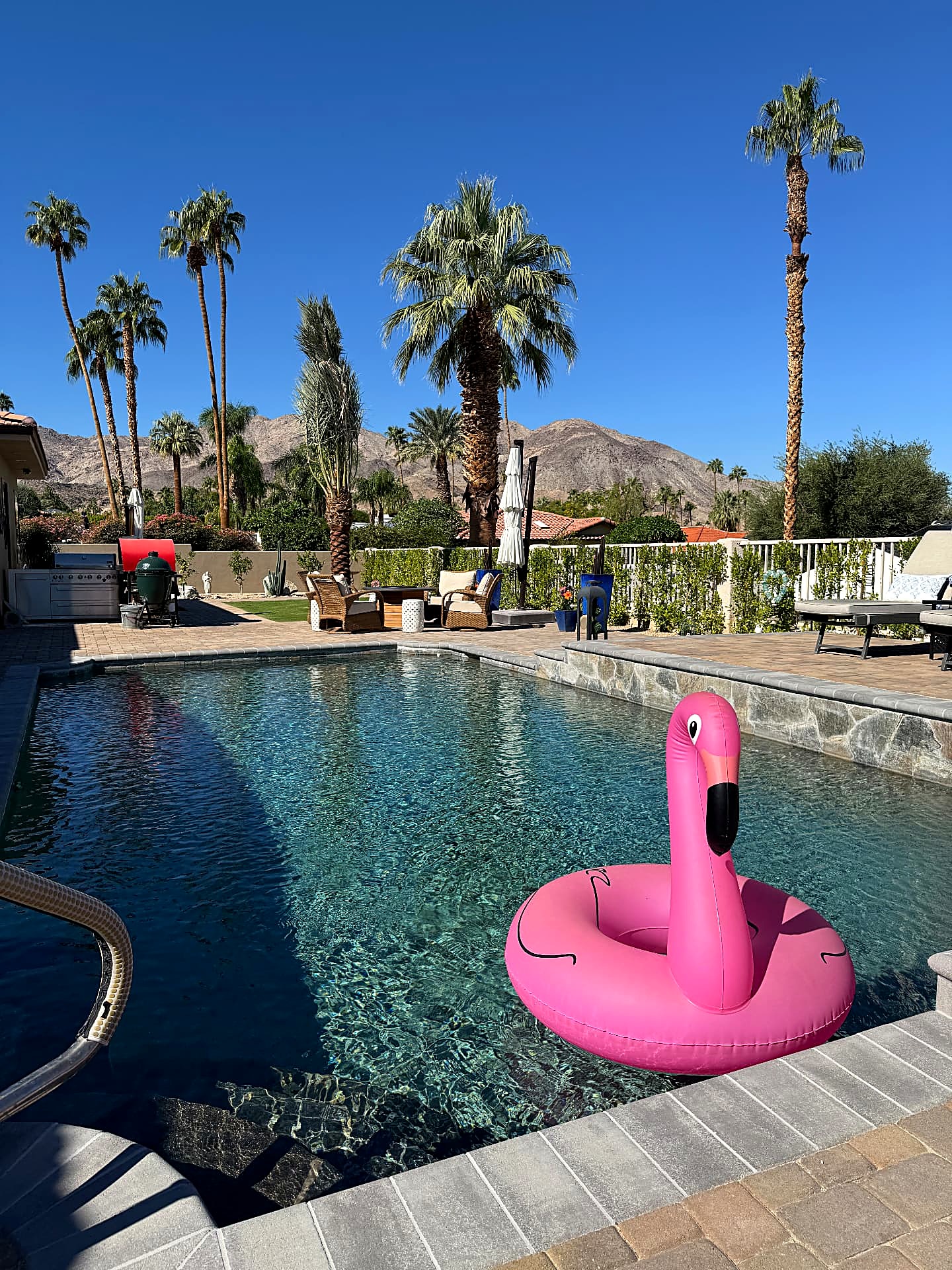 After — remodeled pool with stone coping, paver deck and mountain views